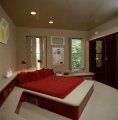 dormitor modern cu pat rosu si tablou